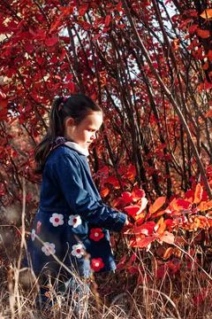 Side view kid portrait. cute little girl in blue jeans coat with embroidery Stock Photos
