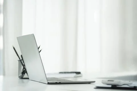 Side view laptop computer, calculator, document and notebook and white offi.. Stock Photos