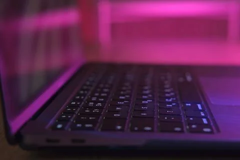 Side View of laptop computer at night. No people. Close Up keyboard, button.. Stock Photos