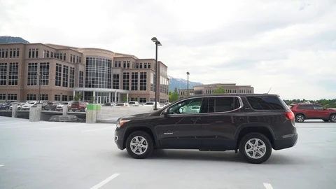 Side view of a large family crossover on the background of a large building Stock Footage 124917560
