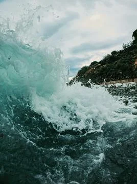 Side view of a large foaming wave. waves at the seaside Stock Photos