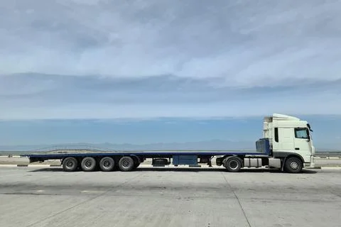 Side view of a large length cargo big truck with copy space on a blue sky Stock Photos