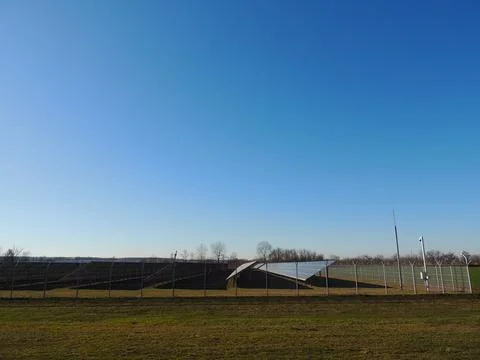 Side view of a large solar panel station outside the city Stockfoto's
