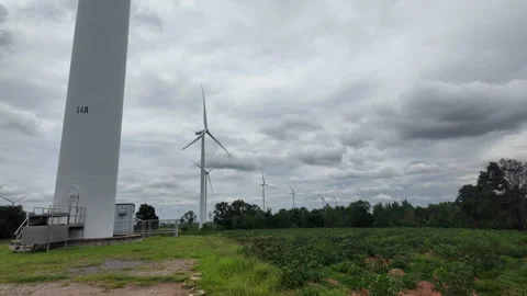 Side view of large white wind turbine tower in rural field farm Stock Footage 343197044