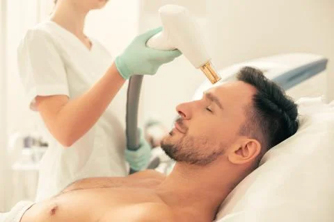 Side view of the laser stretch mask removal procedure Stock Photos