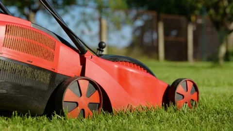 Side view of lawn-mower machine cutting grass outdoors in garden. Close up of an Stock Footage 201969109