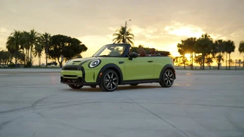 Side view of light green Mini Cooper S Convertible standing with roof down Stock Footage 261247722