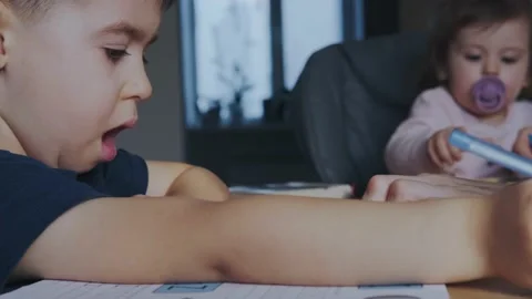 Side view of little boy writing with colorful pencils letters and numbers while Video stock 172227393
