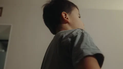 Side view of a little child makeing funny face, gesticulating while playing at Stock Footage 265132343