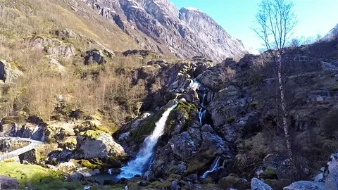 Side view of little waterfall surrounded by rocks at Briksdal glacier in Norway 動画素材 90728334