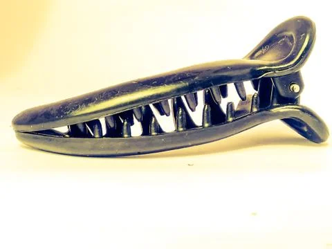 A side view of a long claw type party hair clip placed isolated. Stock Photos