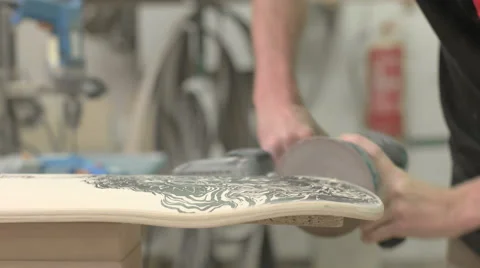 Side view look at man sandering deck Stock Footage 58304980