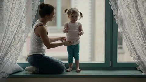 Side View of Loving Mother with Charming Smile and Cute Daughter with Two Ponyta Stock Footage 73673069