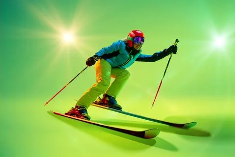 Side view, low angle of athletic woman, skier gliding forward against intense Stock Photos