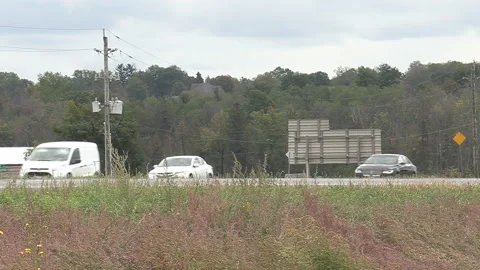Side view low angle of car and truck traffic speeding by  fast on highway Video stock 161854343