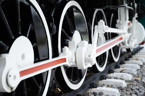 Side view of the lower shock The iron wheels of a steam locomotive on the t.. Stock Photos