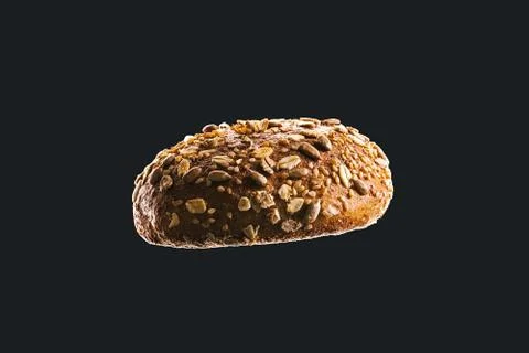 Side view macro of bread isolated on black background. Dark and moody food co Stock Photos