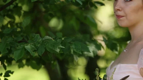 Side view of magical beautiful young blonde bride in elegant dress with bouquet Stock Footage 65502301