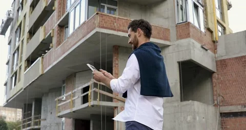 Side view of male architect suing digital gadget for controlling working process Stock Footage 140685003