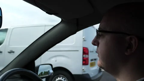 Side view of male driver face driving on a highway in the UK Vídeo Stock 155929531