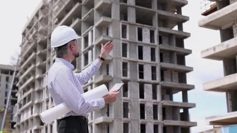 Side view of male engineer standing against background of buildings Stock Footage 340067938