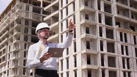Side view of male engineer standing against background of buildings Stock Footage 340067981