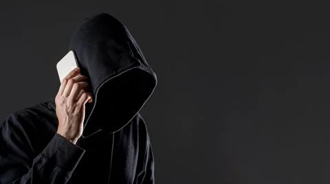 Side view male hacker talking smartphone with copy space . High quality and Stock Photos