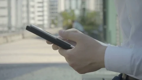 Side view of male hands posting message via white tablet Stock Footage 97922606