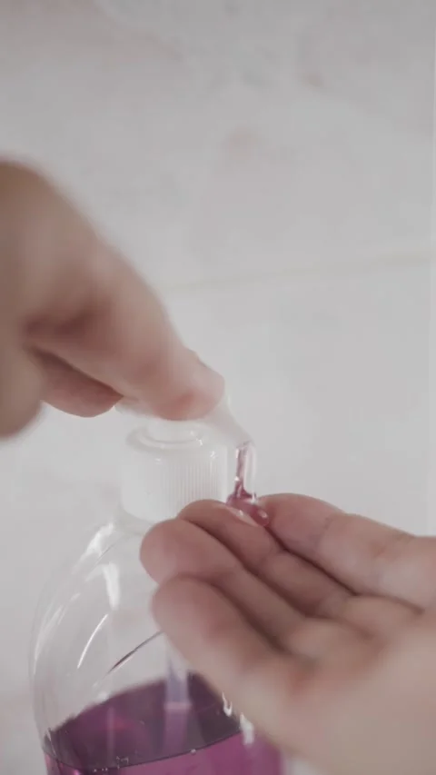 Side view of male hands pouring liquid soap vertical video hygiene care Stock Footage 342240398