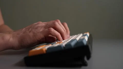 Side view of male hands typing on mechanical computer keyboard. Concept of rapid Stock Footage 342760986