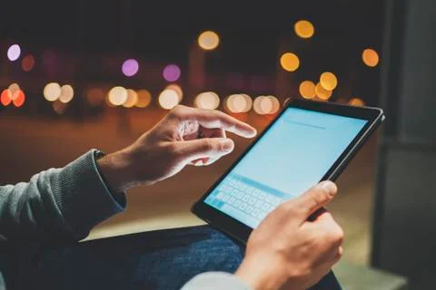 Side view of male hands using modern digital tablet outdoor Stock Photos