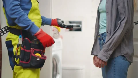 Side View Of Male Plumber Shaking Hands With Client Stock Footage 132393583
