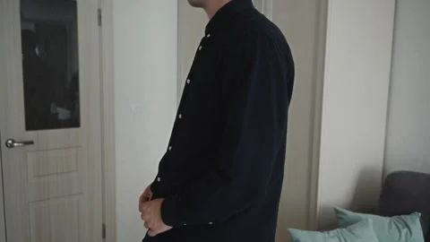 Side view of man adjusting shirt for professional confidence Stock Footage 317553336