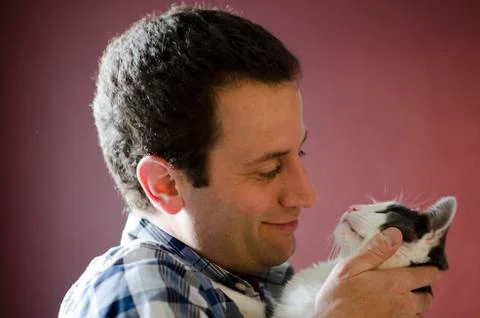 Side view of man and his cat gazing into each other's eyes. Stock Photos
