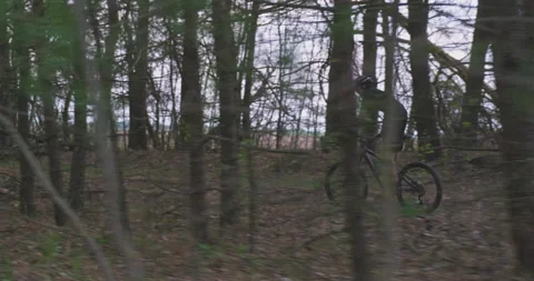 Side view to the man in a Bicycle helmet fast riding an mtb bike. Young sport Stock Footage 130769433