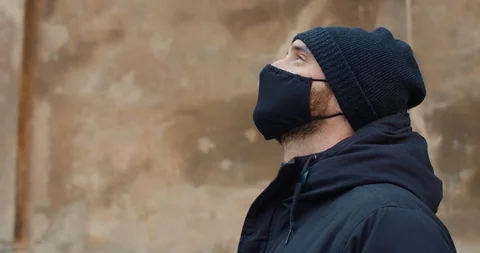 Side view of man in black cotton protective mask. Close up view of guy standing Stock Footage 127576804