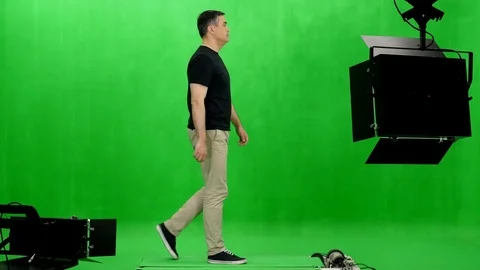 Side view of a man in black t-shirt walking on a treadmill in chromakey studio Stock-Footage 77718543