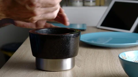Side view of man crushing some nuts in a mortar Stock Footage 128825427