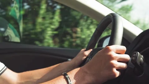 Side view of Man driving a car. detail on hands holding steering wheel. Stock-Footage 336268817