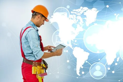 Side view man engineer wearing protective helmet using a tablet computer gadget Stock Photos