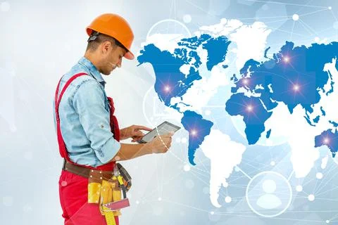 Side view man engineer wearing protective helmet using a tablet computer gadget Stock Photos