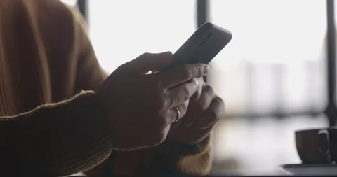Side view of man hands with watch using mobile phone while working at laptop Stock Footage 164675871