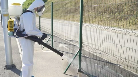 Side view on man in hazard wearing with equipment for disinfection. Stock Footage 140460113