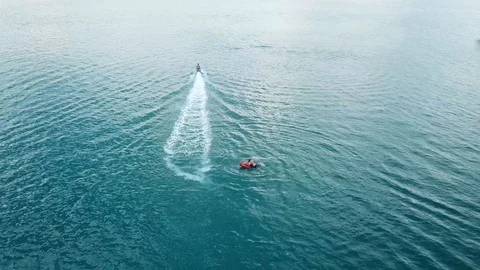 Side view of a man jumping on an electric surfboard 스톡 동영상 88162452