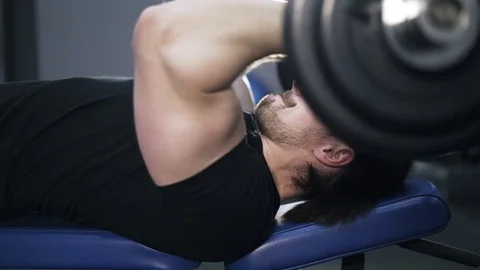 Side view of a man lifting a barbell Stock Footage
