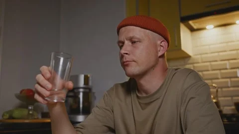 Side view of man mindfully drinking water in calm daily pause Stock Footage 317554270