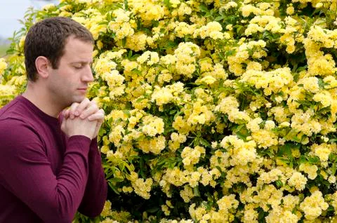 Side view of man praying outside. Stock Photos