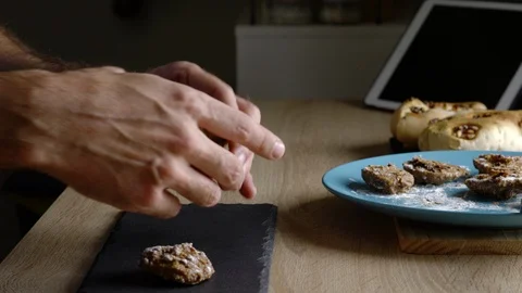 Side view of a man preparing oatmeal, banana and chocolate cookies Stock Footage 128828784