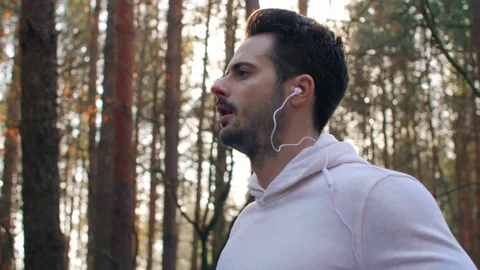 Side view of man running and listening to music Stock Footage 102826007