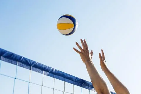 Side view man s hands preparing hit incoming volleyball net . High quality and Stock Photos